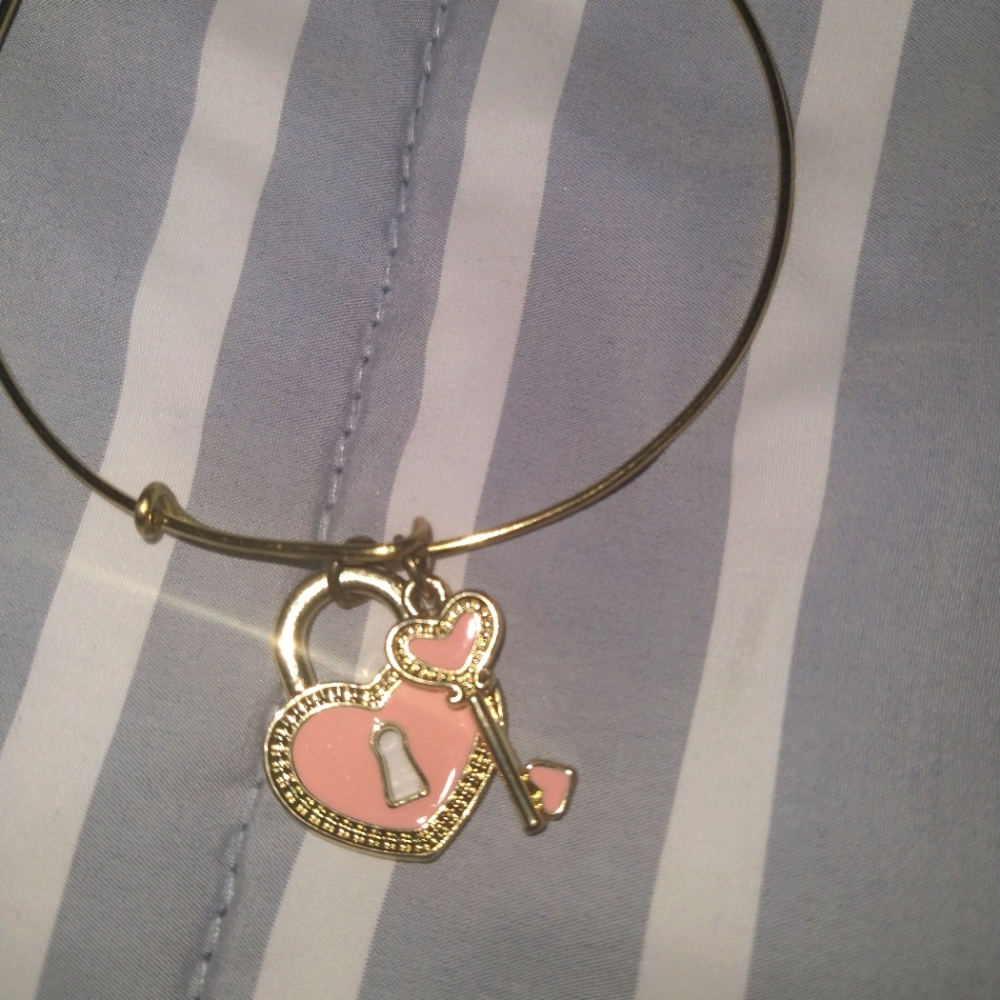 Gold bracelet with pink key charm